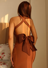 Back view of Opera dress with large bow and open-back design