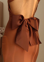 Close-up of bow detail and backless cut on rust-colored nylon lycra bodycon dress